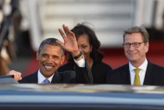 US President Barack Obama and US First Lady Michelle Obama are greeted by German foreign minister Guido Westerwelle (R) upon arrival at Berlin Tegel airport on June 18, 2013. Barack Obama will walk in John F. Kennedy's footsteps this week on his first visit to Berlin as US president, but encounter a more powerful and sceptical Germany in talks on trade and secret surveillance practices.  AFP PHOTO / ODD ANDERSEN