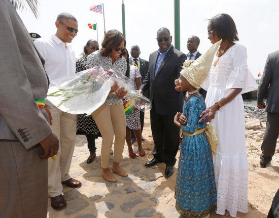 U.S. President Barack Obama and first lady Michelle Obama receive a bouquet as they arrive on Goree Island near Dakar