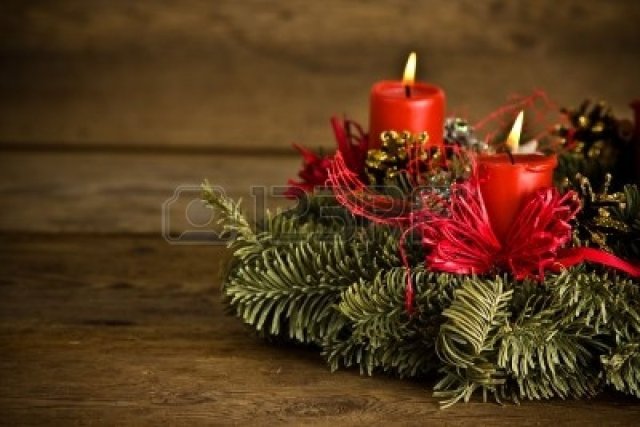 6266588-green-christmas-wreath-decorated-with-red-burning-candles-red-ribbons-and-golden-pine-cones-on-timbe