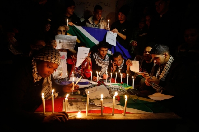 Mandela Mourning- Palestinians attend a candlelight vigil for Mandela in Gaza City on Sunday