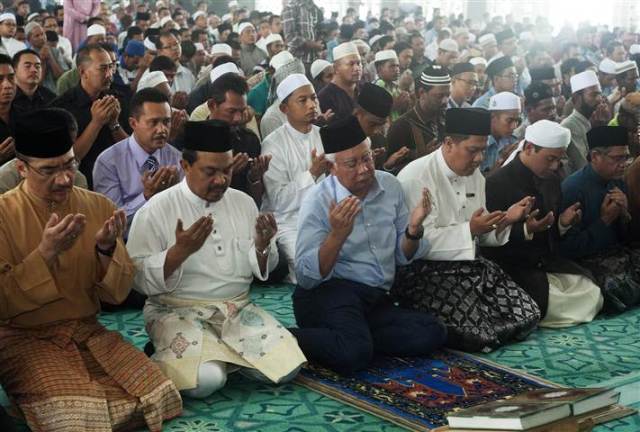 Malaysian Prime Minister Najib Razak, 3rd from left, attends a special prayer at a mosque near Kuala Lumpur International Airport.